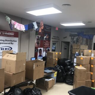 Employees of The ROP Shop and Outdoor Concepts sort and pack clothing to be shipped out by Forgotten Children Worldwide to needy around the world.