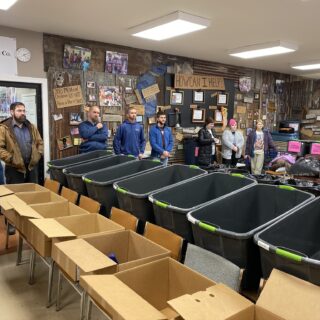 Employees of The ROP Shop and Outdoor Concepts sort and pack clothing to be shipped out by Forgotten Children Worldwide to needy around the world.