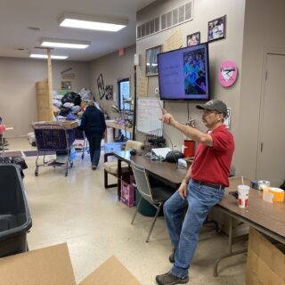 Employees of The ROP Shop and Outdoor Concepts sort and pack clothing to be shipped out by Forgotten Children Worldwide to needy around the world.