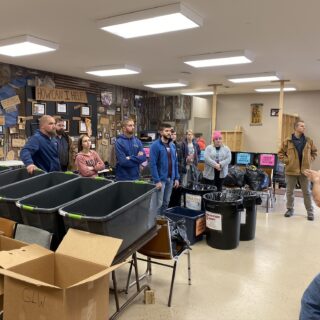 Employees of The ROP Shop and Outdoor Concepts sort and pack clothing to be shipped out by Forgotten Children Worldwide to needy around the world.