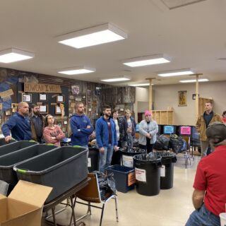 Employees of The ROP Shop and Outdoor Concepts sort and pack clothing to be shipped out by Forgotten Children Worldwide to needy around the world.