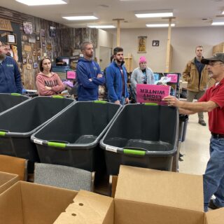 Employees of The ROP Shop and Outdoor Concepts sort and pack clothing to be shipped out by Forgotten Children Worldwide to needy around the world.