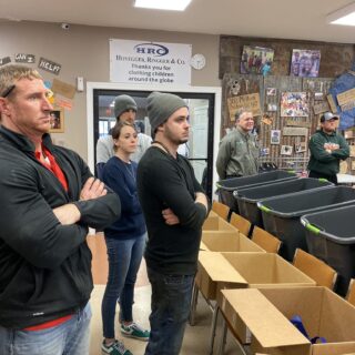Employees of The ROP Shop and Outdoor Concepts sort and pack clothing to be shipped out by Forgotten Children Worldwide to needy around the world.