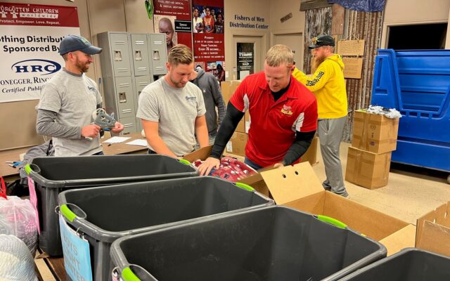 Employees of The ROP Shop and Outdoor Concepts sort and pack clothing to be shipped out by Forgotten Children Worldwide to needy around the world.