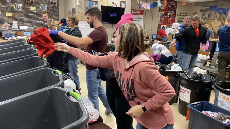 Employees of The ROP Shop and Outdoor Concepts sort and pack clothing to be shipped out by Forgotten Children Worldwide to needy around the world.