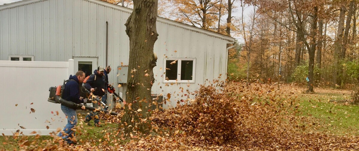 Employees of The ROP Shop and Outdoor Concepts help cleanup the grounds of Gateway Woods, an outreach for people in need.