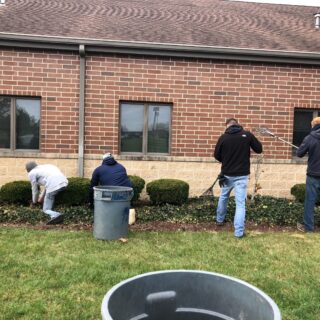 Employees of The ROP Shop and Outdoor Concepts help cleanup the grounds of Gateway Woods, an outreach for people in need.