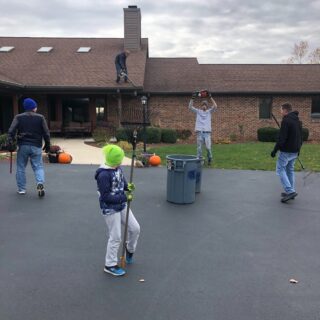 Employees of The ROP Shop and Outdoor Concepts help cleanup the grounds of Gateway Woods, an outreach for people in need.