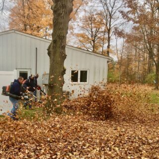 Employees of The ROP Shop and Outdoor Concepts help cleanup the grounds of Gateway Woods, an outreach for people in need.