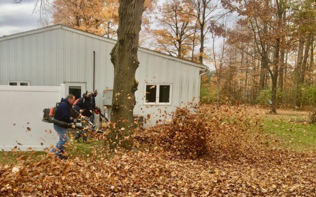 Employees of The ROP Shop and Outdoor Concepts help cleanup the grounds of Gateway Woods, an outreach for people in need.