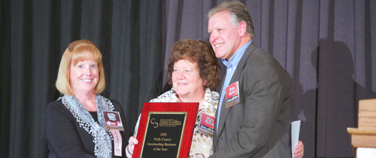 Steve and Gayla Gerber accept the award for business of the year, presented to The ROP Shop's parent company, Outdoor Concepts.