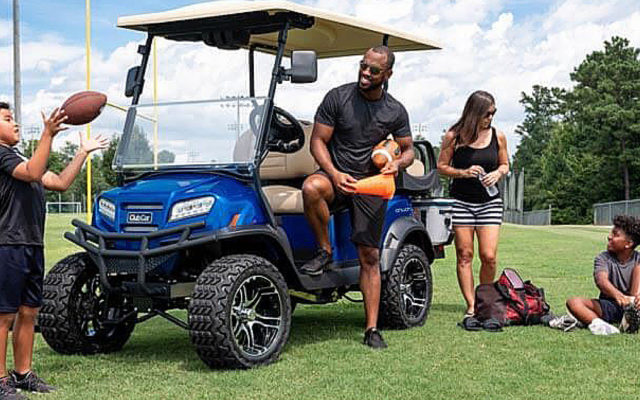 Family is hanging out around a street legal custom golf cart