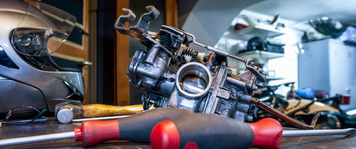 Image of a carburetor being worked on.