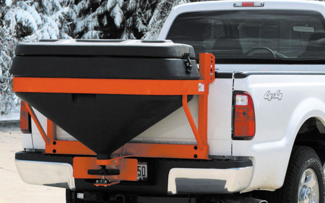 Truck using a salt spreader system in winter time.