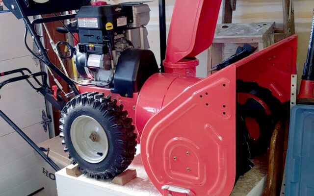 Snowblower on stand in garage.