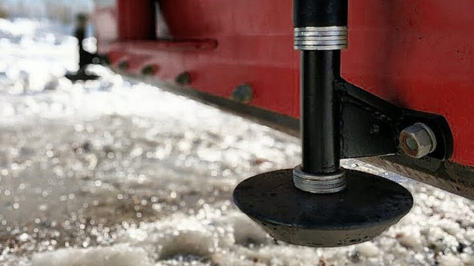Snowplow skid shoes attached to a plow