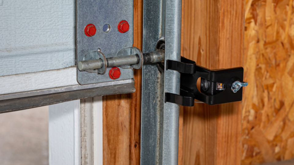 A close-up of a garage door photo sensor