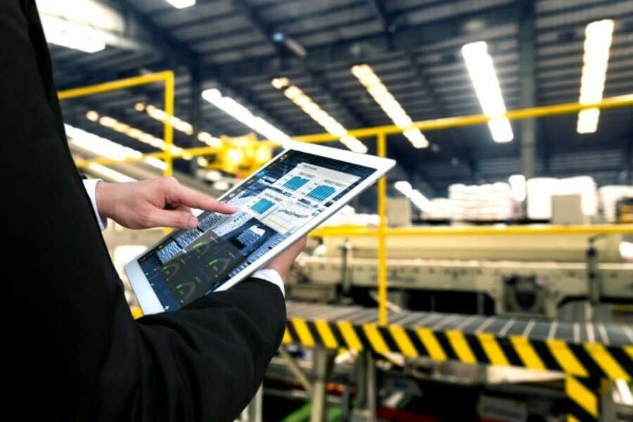 person in warehouse using tablet to track supply chain