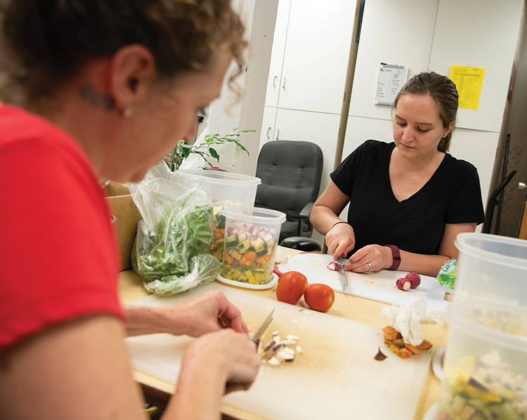 Caretakers Gretchen Long and Kelsey Lingenfelter Caretakers Gretchen Long and Kelsey Lingenfelter prepare the animals’ food