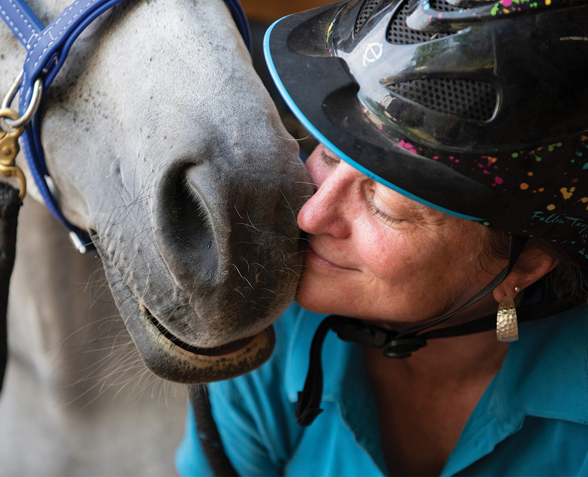 Jamie Hendry and Rachel Jamie Hendry gives Rachel some love before saddling up for a ride in her arena.