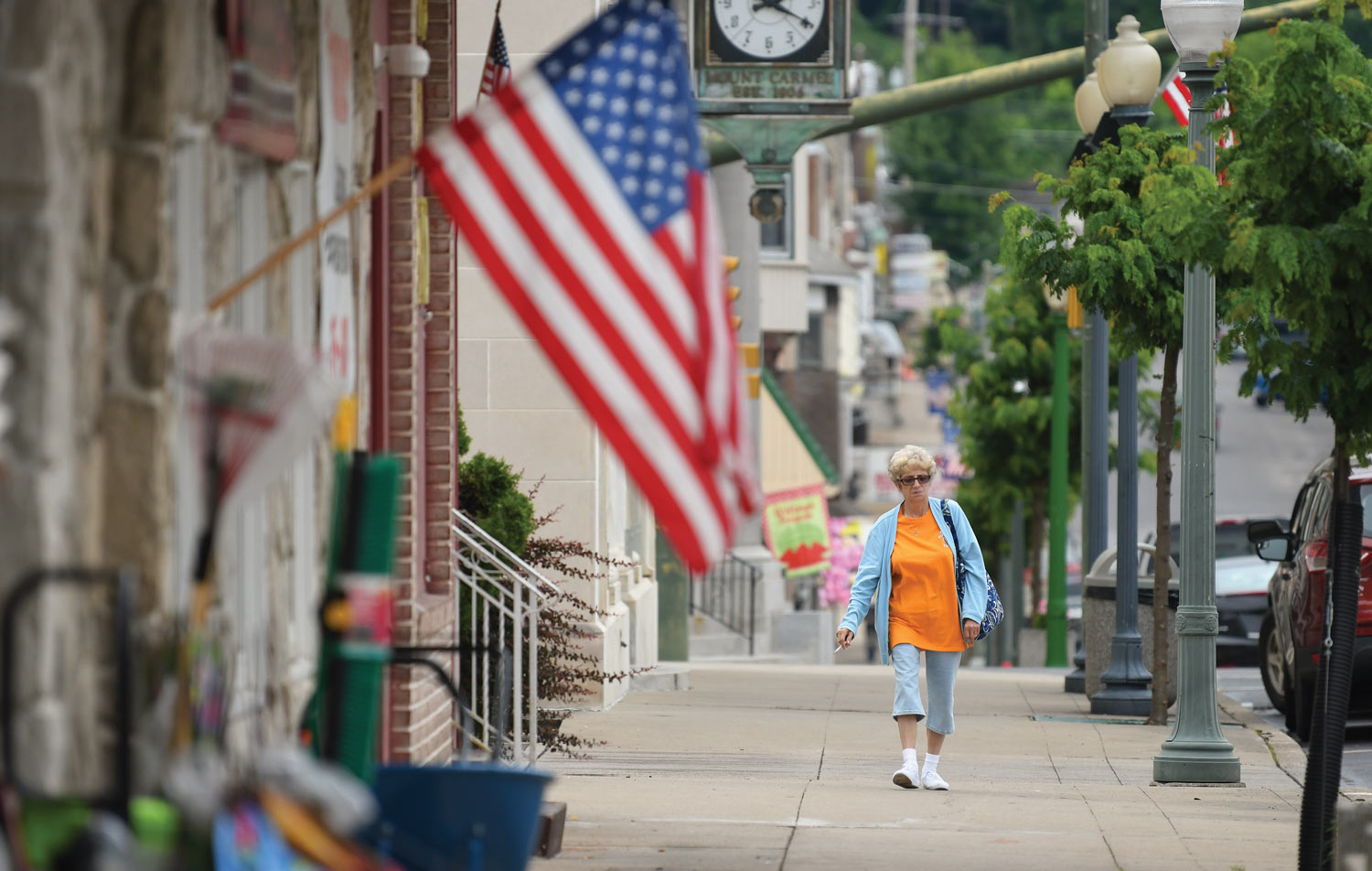 Many of the women interviewed for the research project live in Mt. Carmel, a coal town that has been in decline for decades woman walking down the sidewalk in Mt. Carmel smoking a cigarette