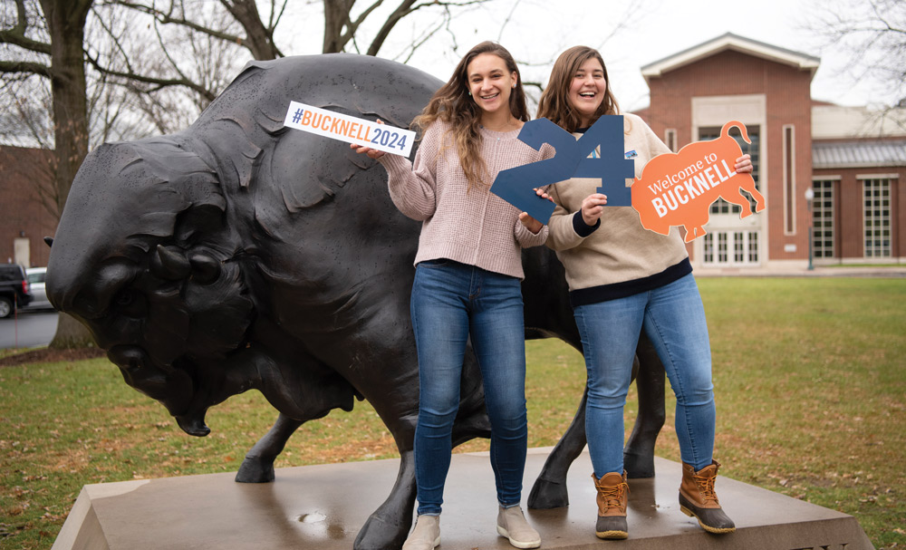 Bucknell students in front of a Bison statue Bucknell students posing with spirit signs