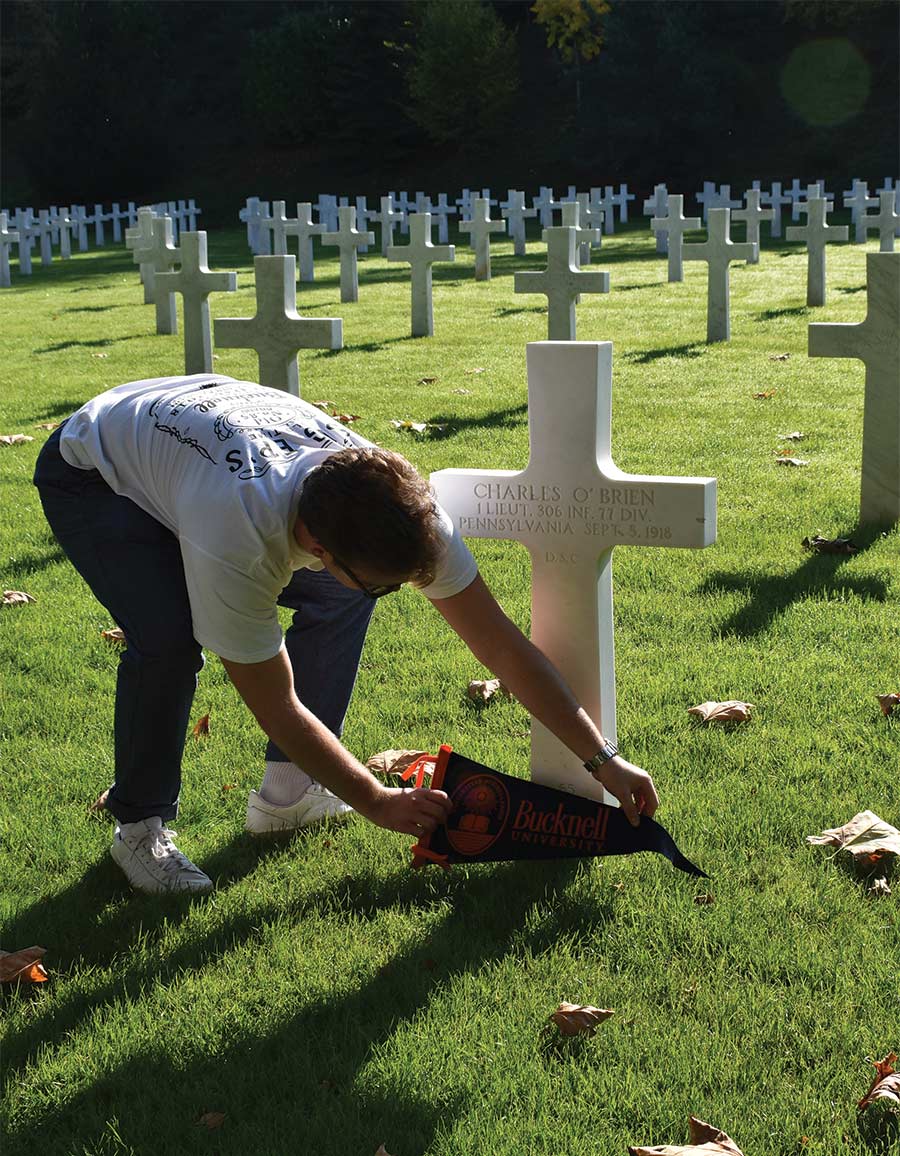 Peter Stokes ’21 Peter Stokes ’21 places a pennant on a Bucknellian’s grave in France.