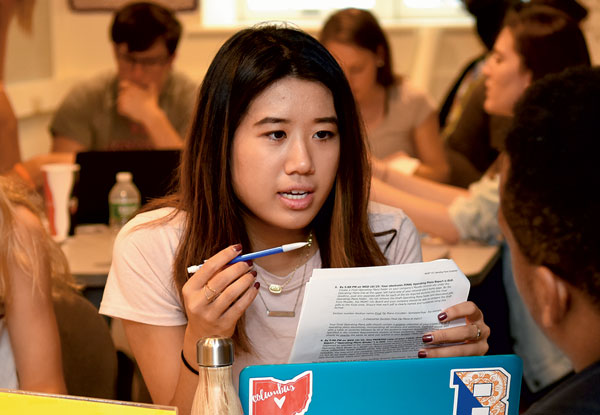Students engaging with each other during a Management 101 class