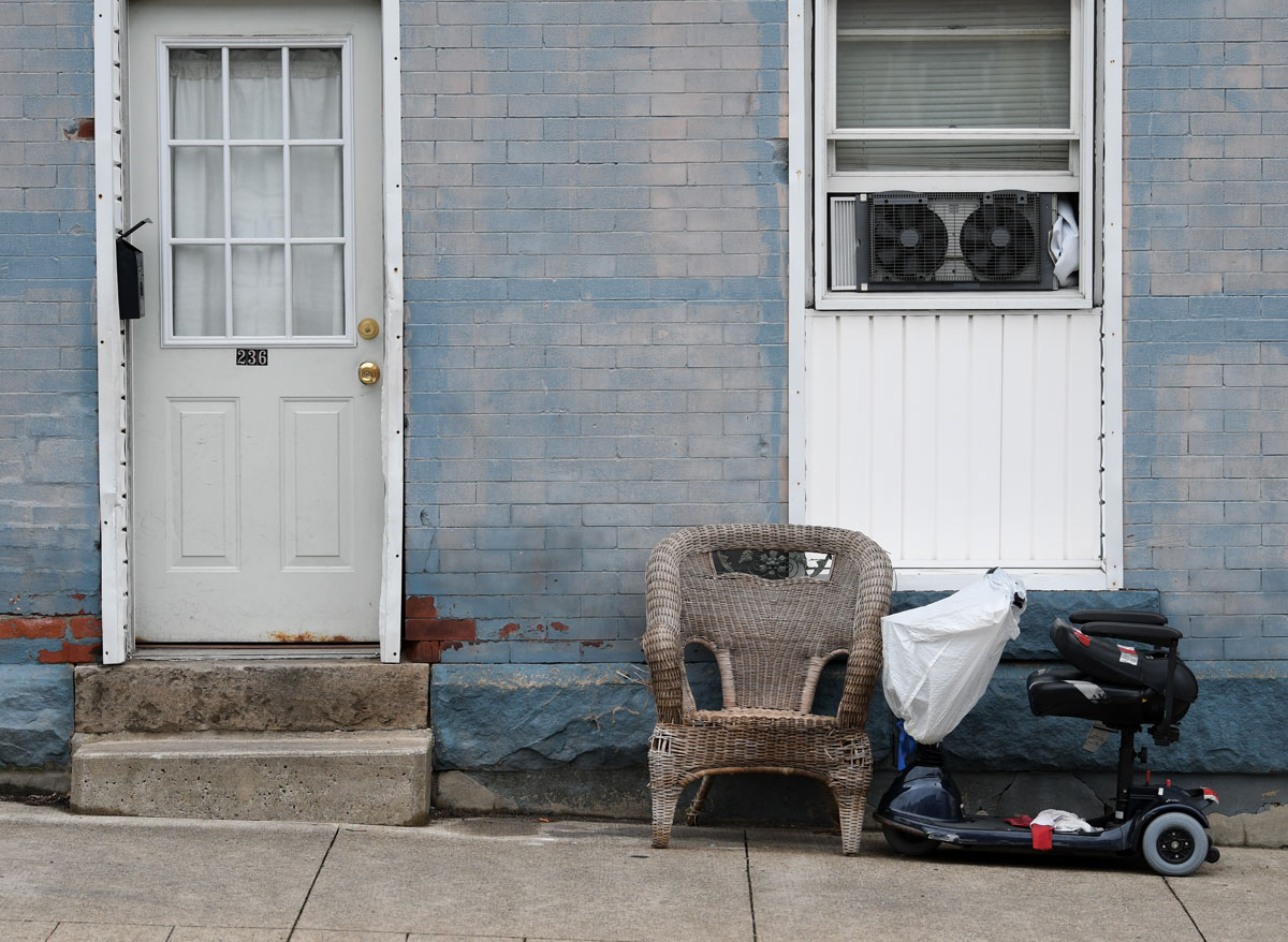 Scooter and chair in front of a home