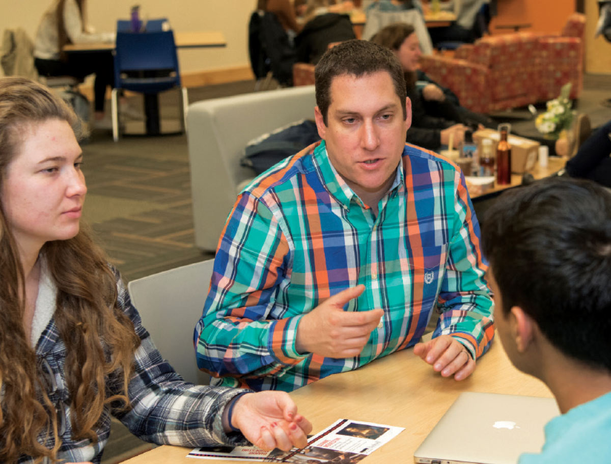 Mike Duignan (center) advises student activities leaders on event planning.