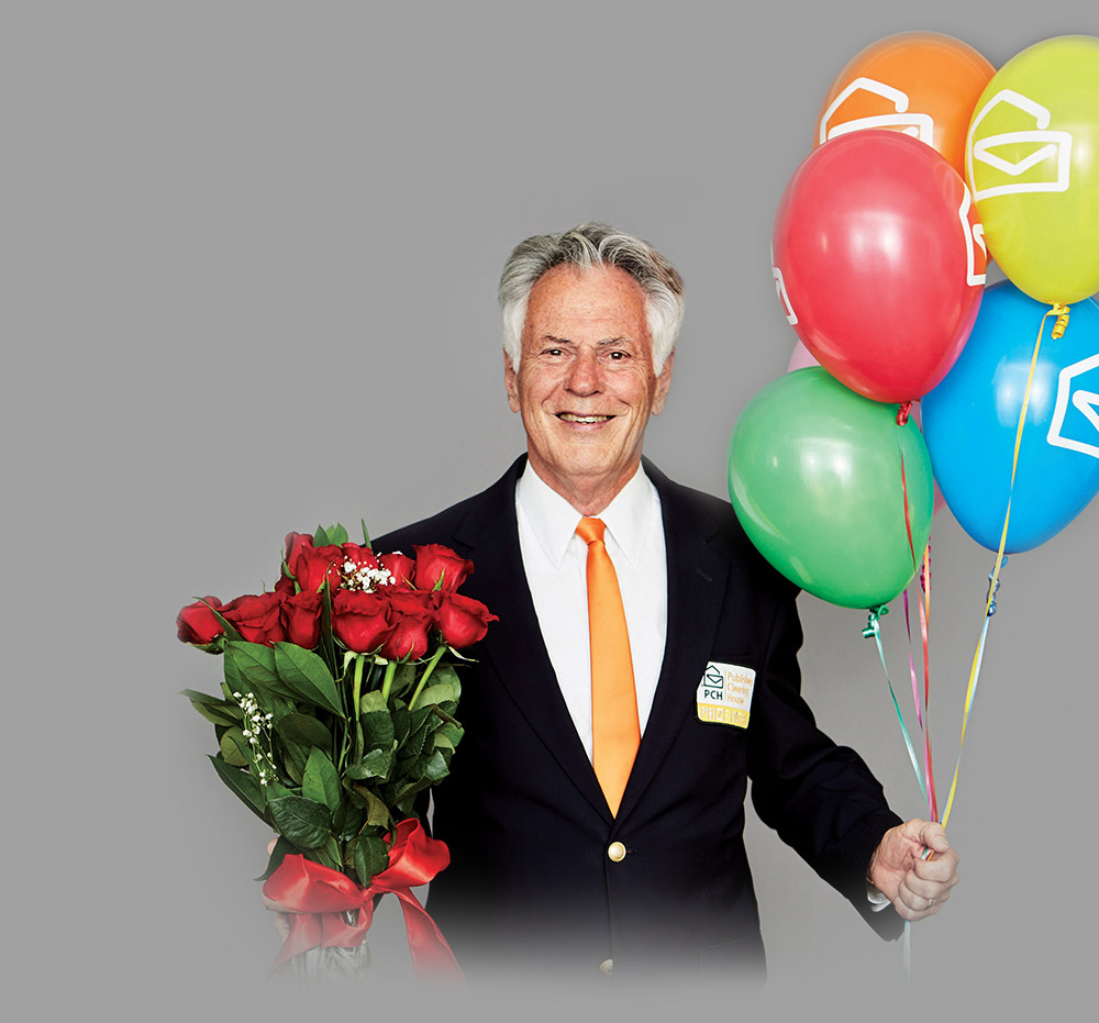 Dave Sayer Dave Sayer smiling and holding roses and balloons