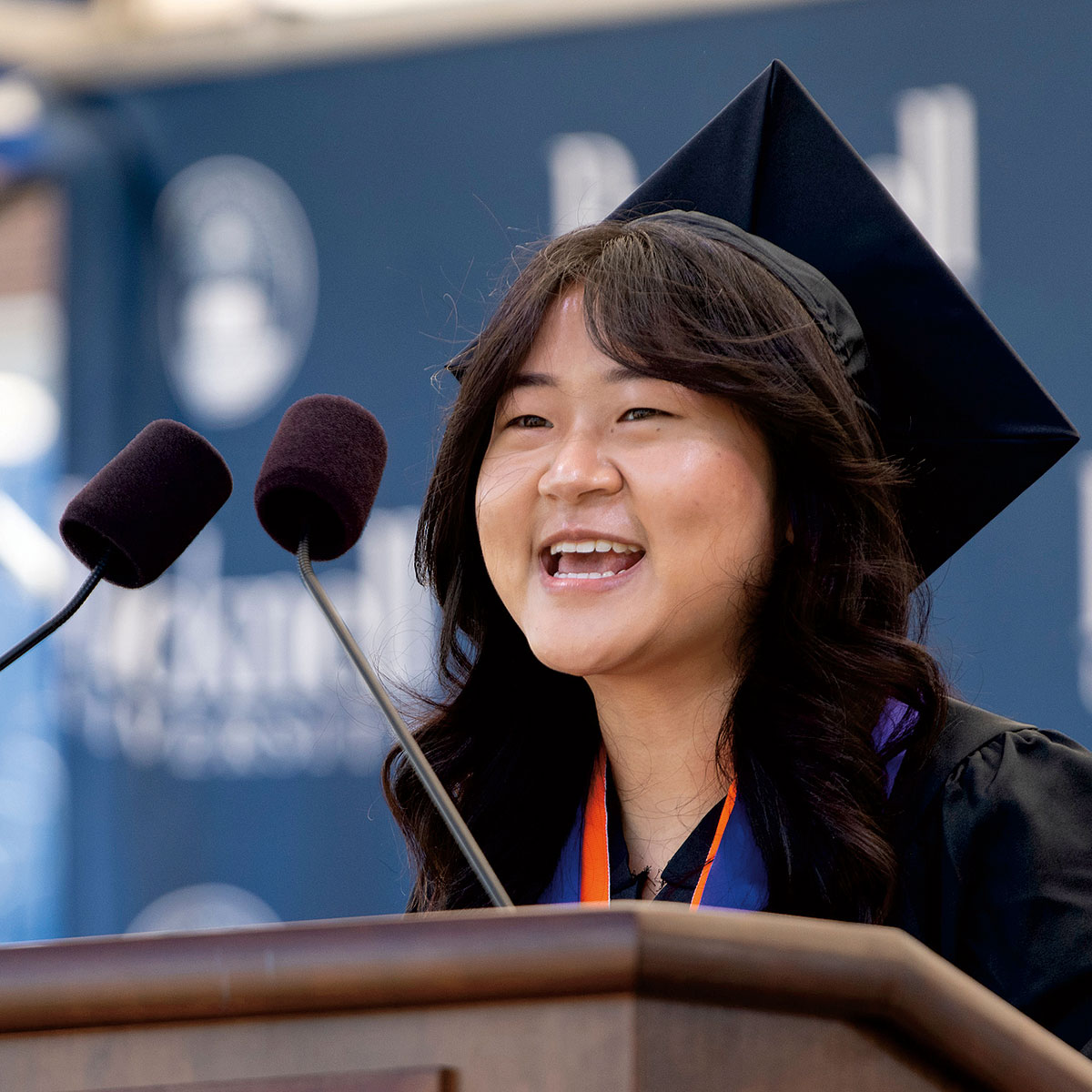 Ruby Lee ’21 Ruby Lee ’21 in a graduation cap and gown giving her speech at at Bucknell’s 171st Commencement