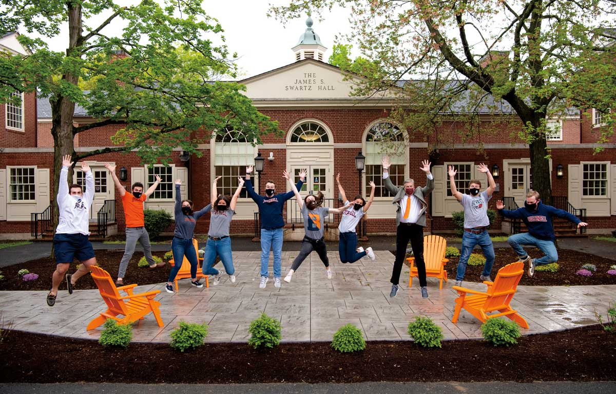 Class of 2021 students celebrate by jumping mid air