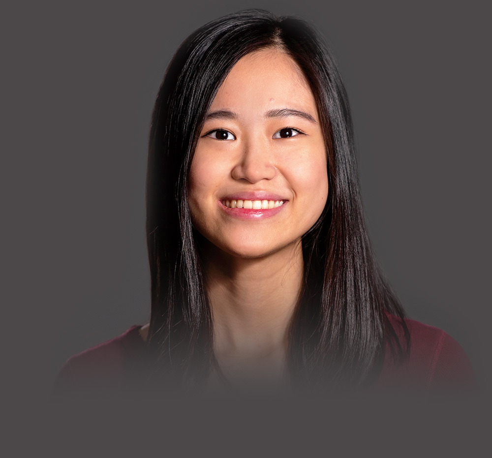 Wutt Kyi Wutt Kyi smiling against a gray backdrop in a professional photo