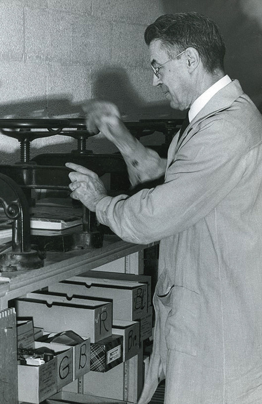 old photograph of a man working in a shop