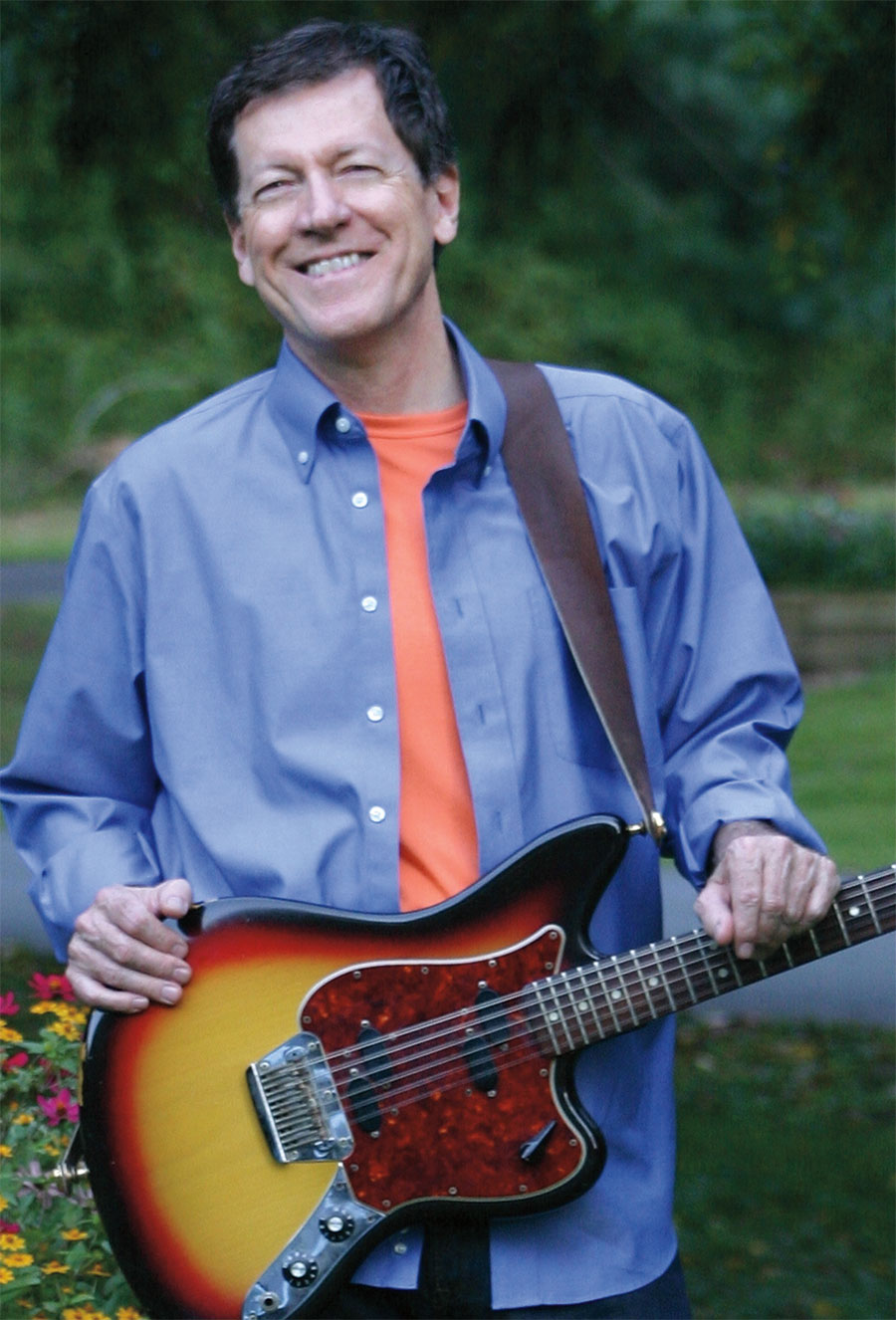 Jonathan Sprout holding his guitar