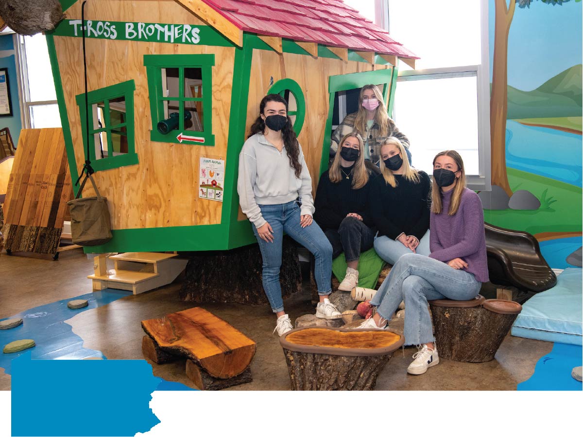 Design Realization students gathered near a playhouse