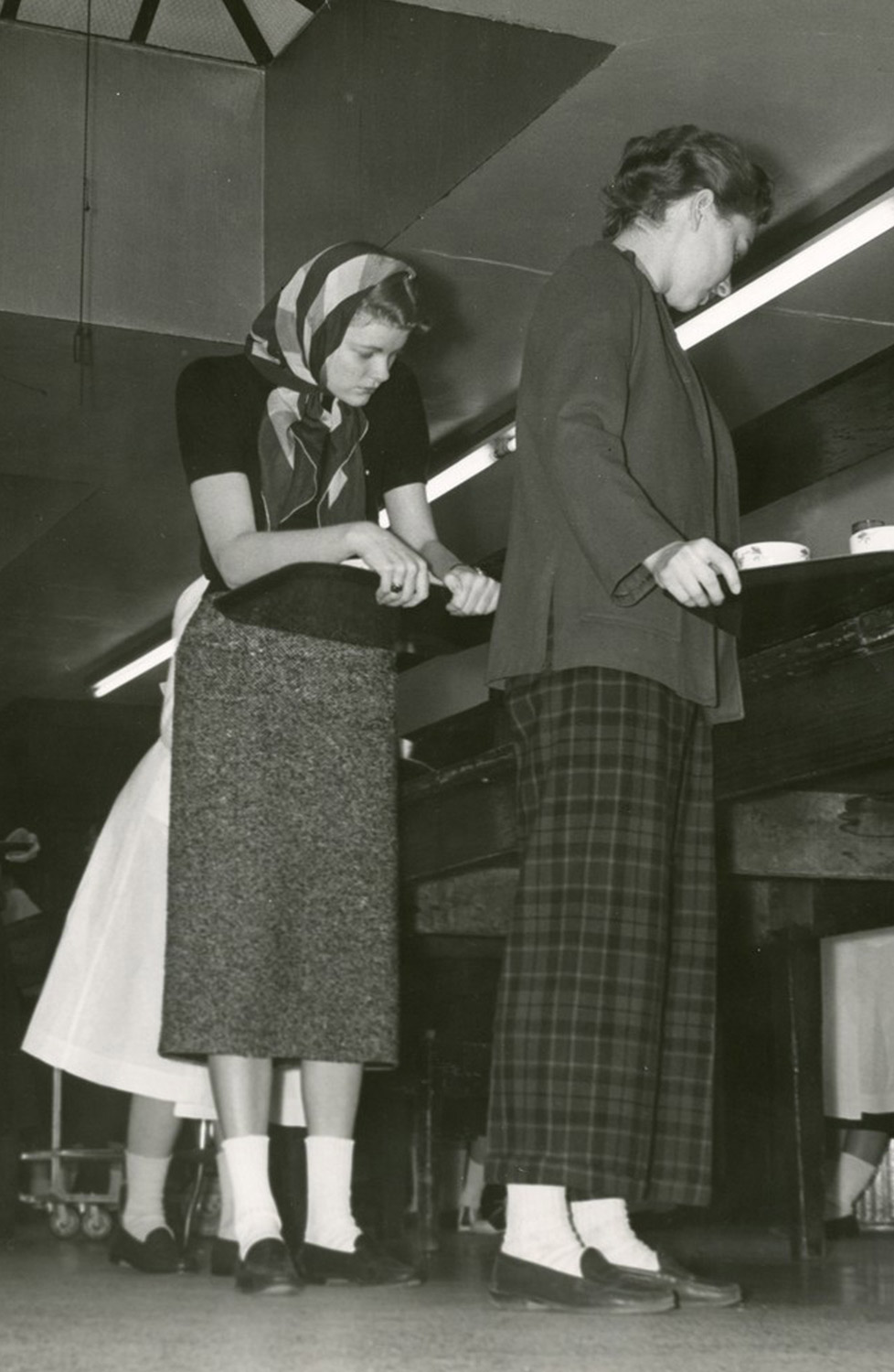 Witty Winners old black and white photo of two women holding trays and standing in line to receive food