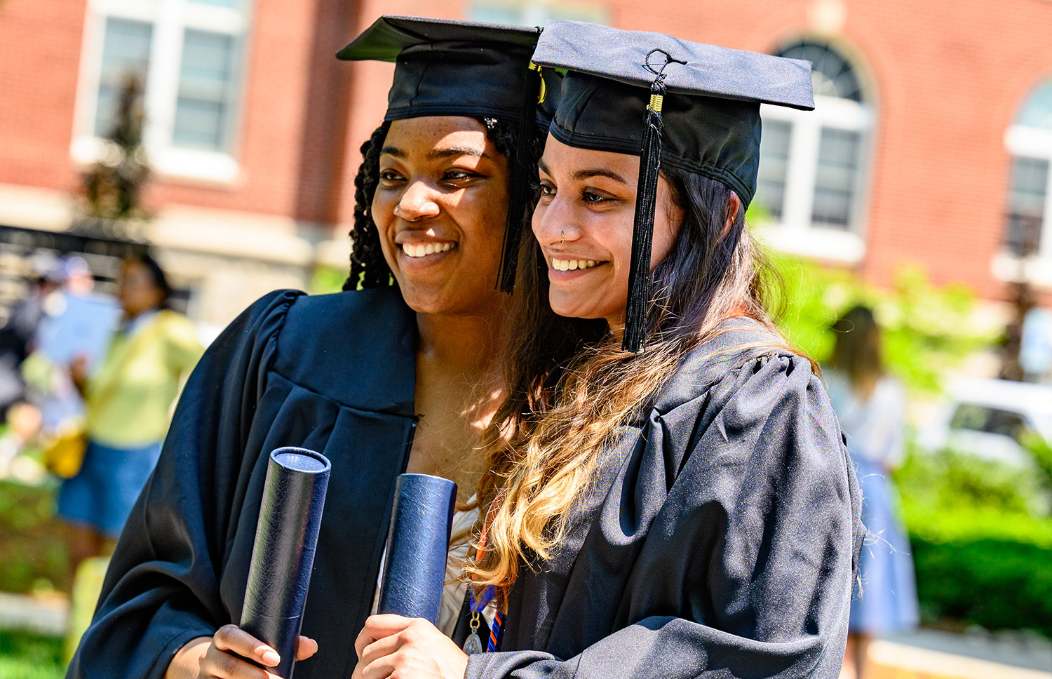 Two graduates posing for a picture