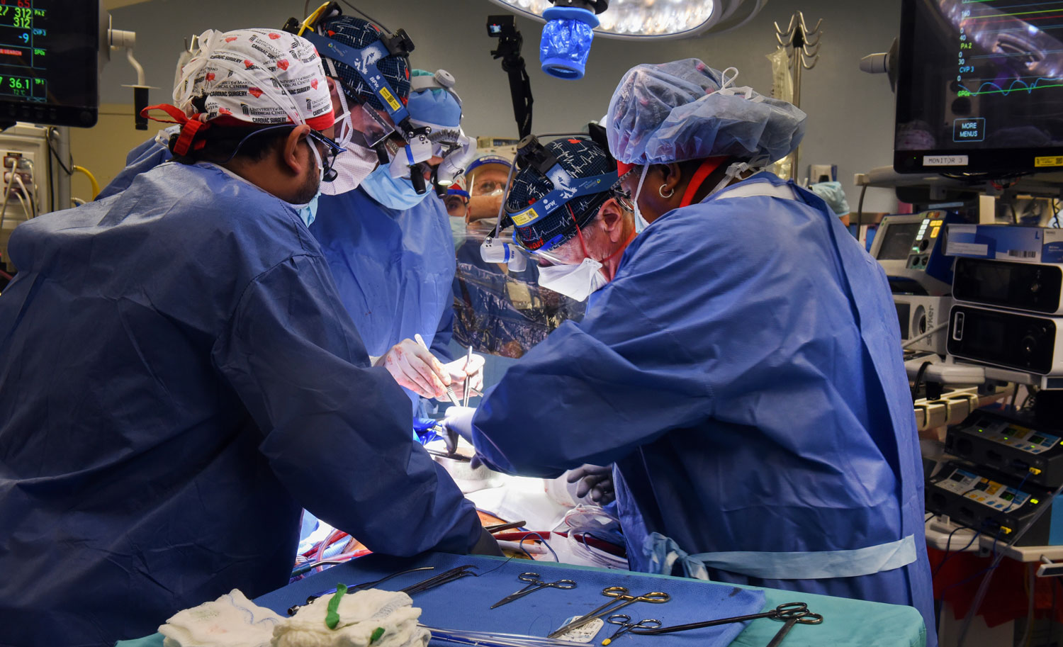 Griffith (second from right) performs the seven-hour xenotransplant surgery. The pig heart received 10 genetic edits, including the removal of four pig genes and the addition of six human genes