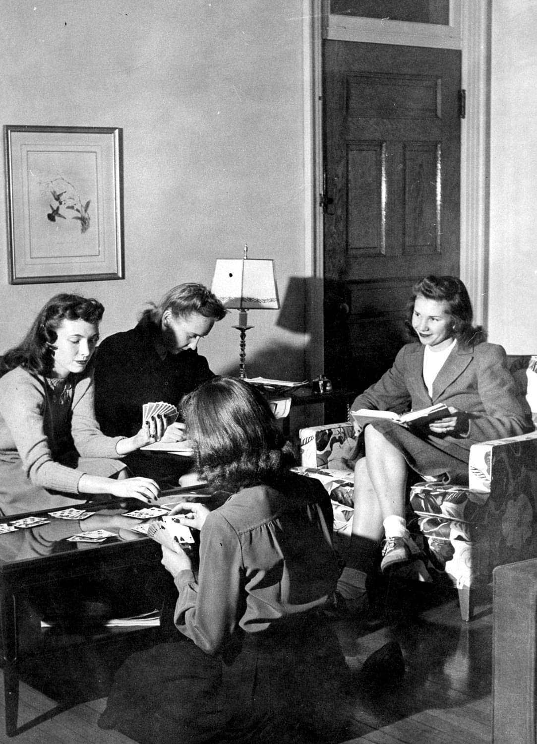 Witty Winners black and white photo of young women playing cards in sitting room