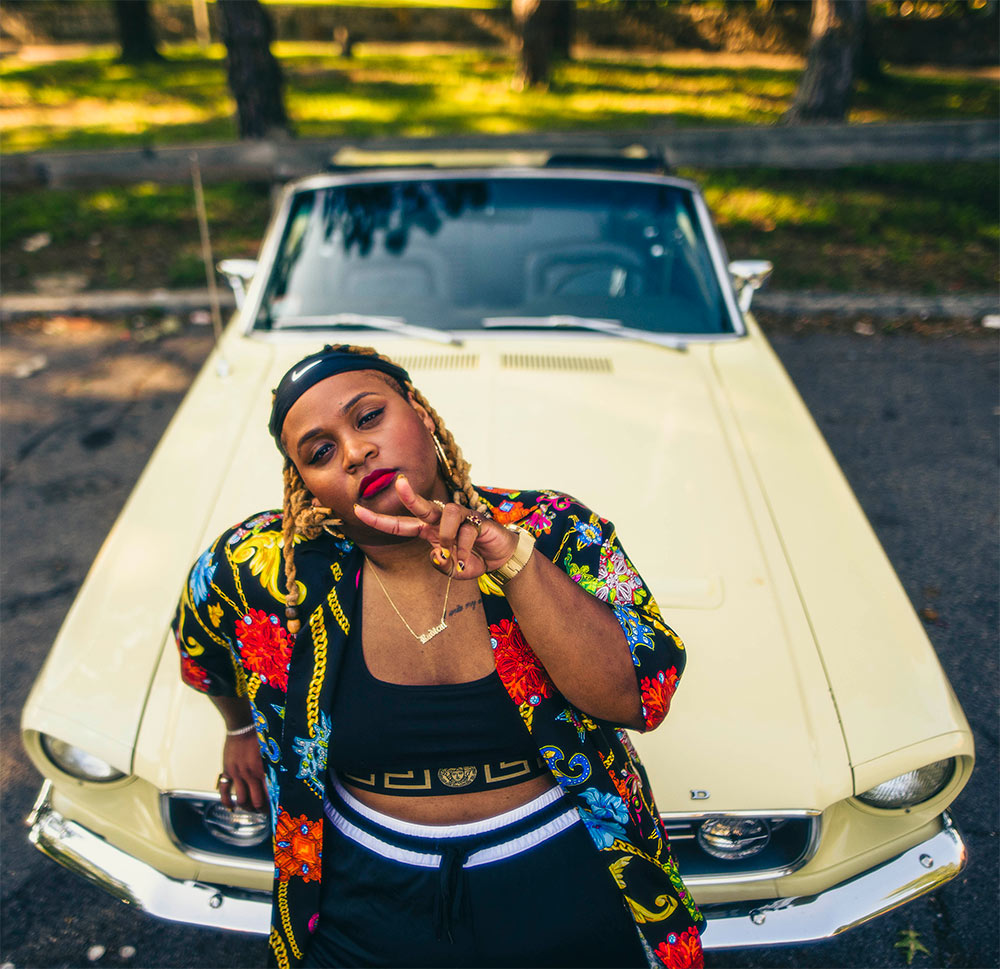 Oompa Williams on hood of original Ford Mustang