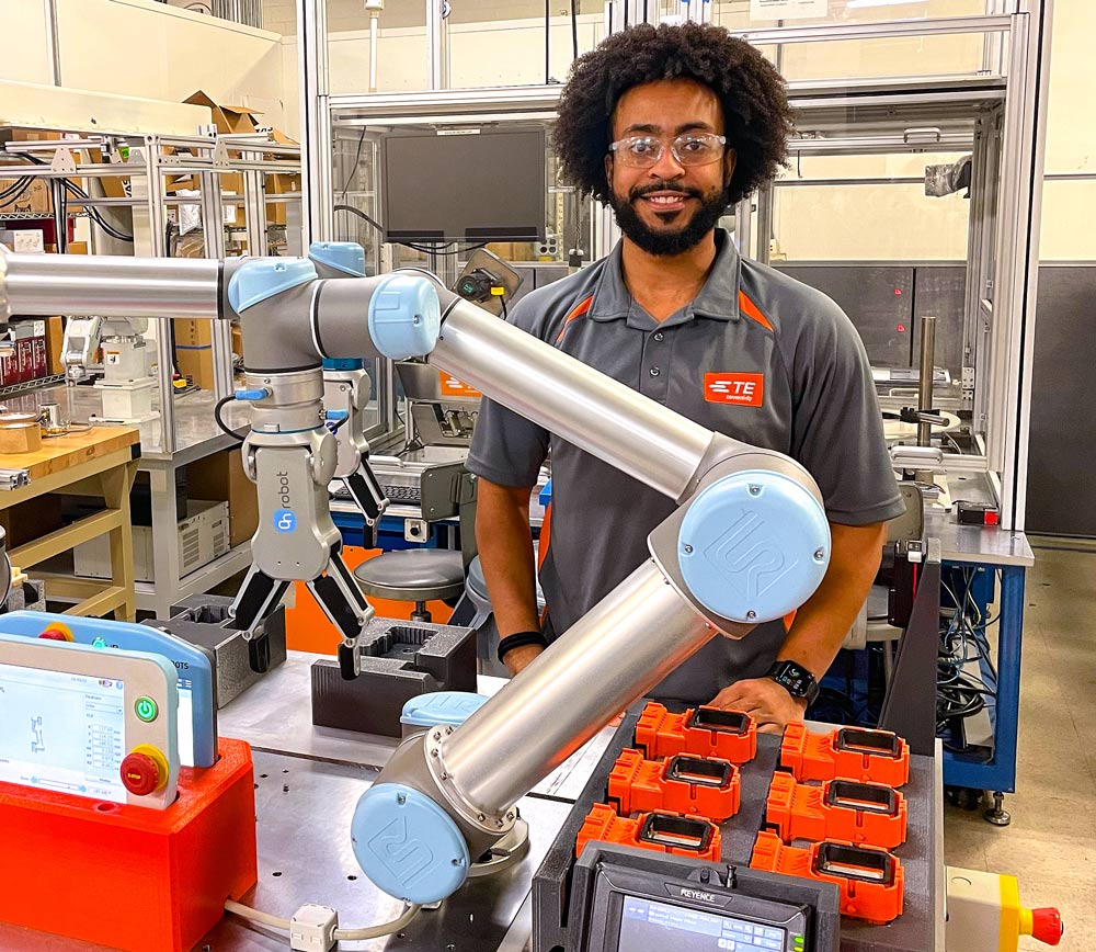 Kellen Haile with robotic arm in front