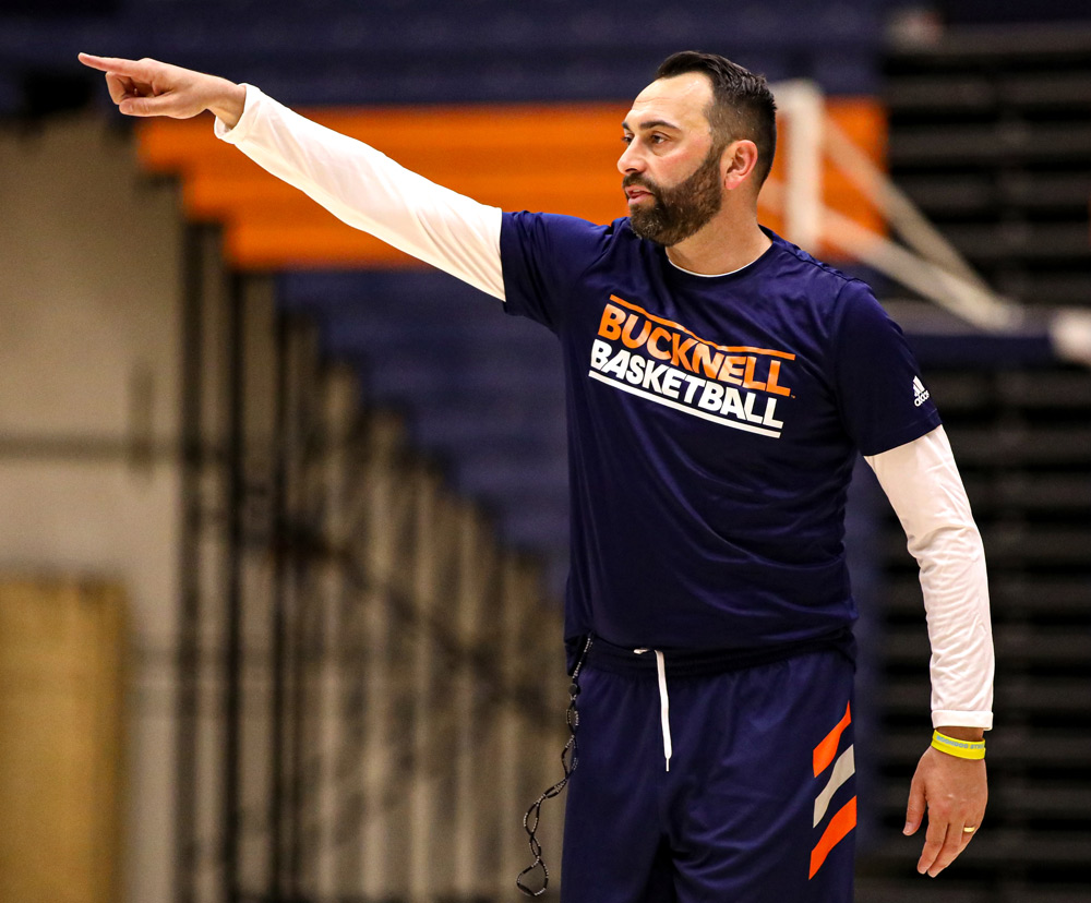 Basketball player for Bucknell on the court pointing his finger.