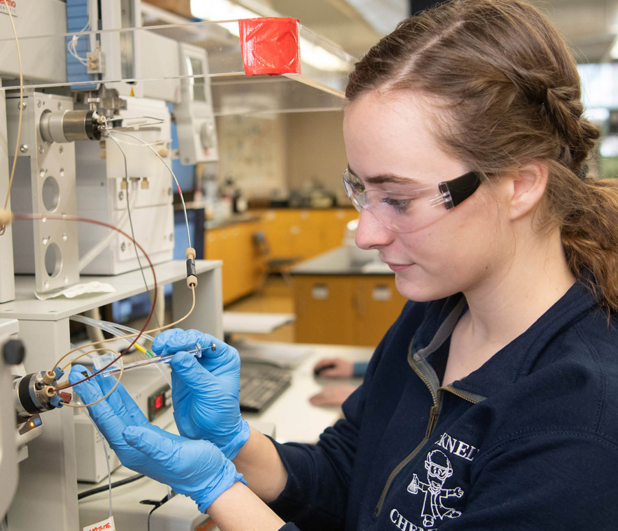 April Hurlock in a lab working on wiring