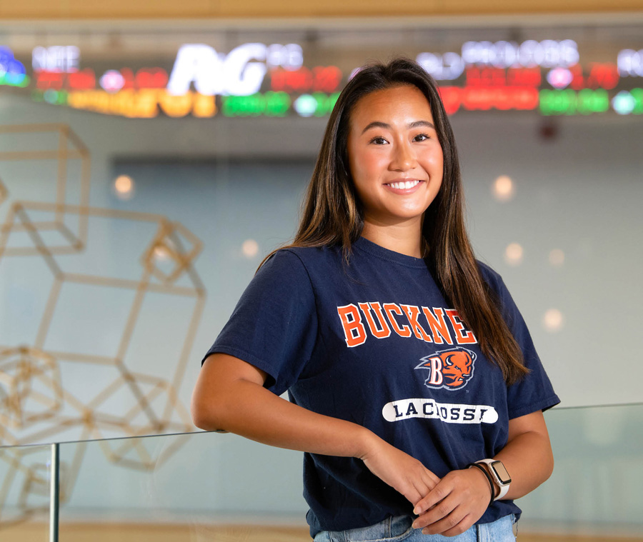 Jamie Tsao smiling, wearing a blue Bucknell shirt