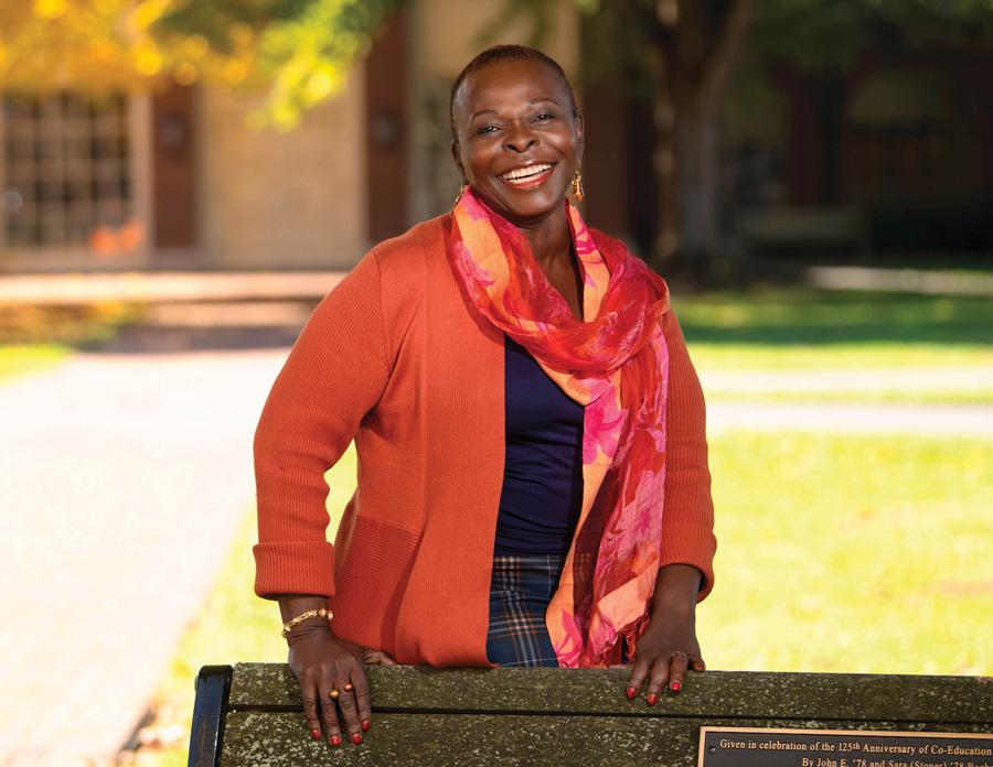Angèle Kingué smiling, wearing an orange cardigan and colorful scarf