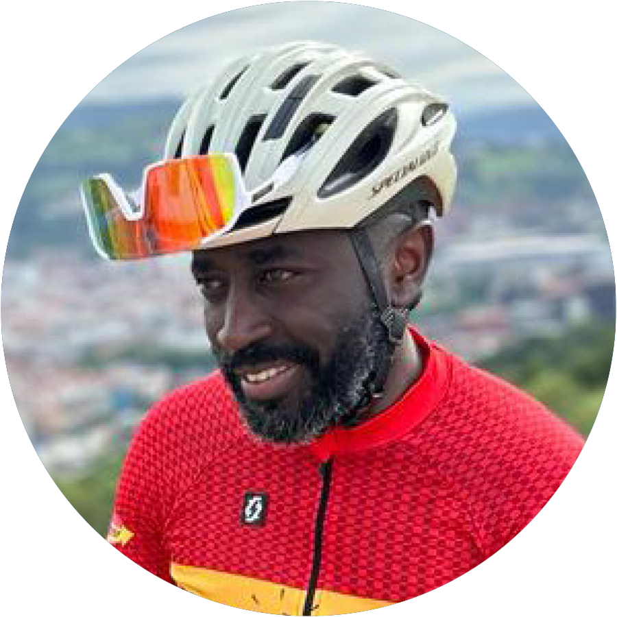 headshot of a Muyambi Muyambi ’12 wearing his biking gear
