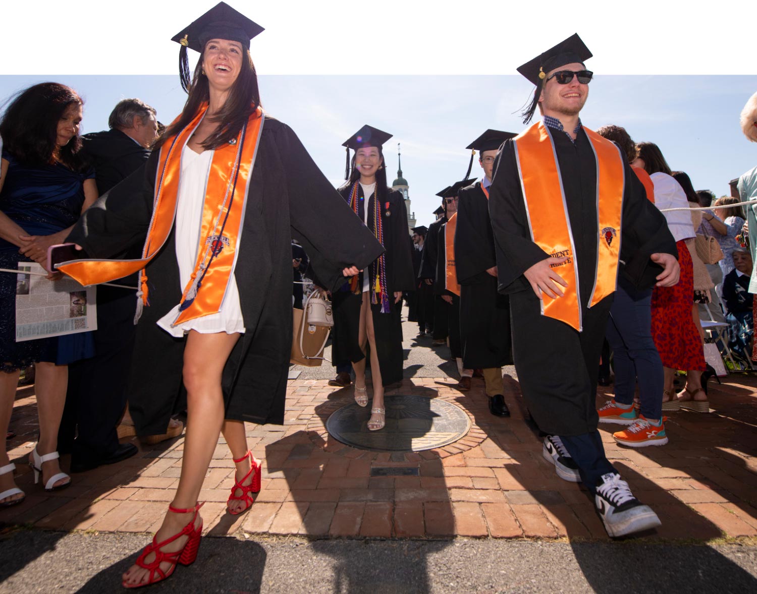 low angle of the grad procession as it travels through the audience center walkway