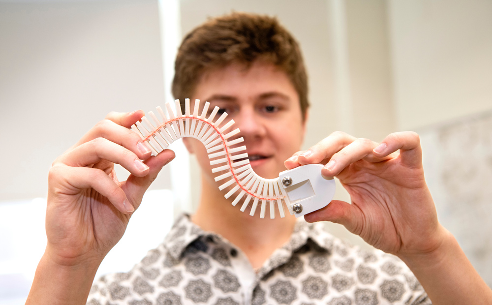 student holding swimming robot